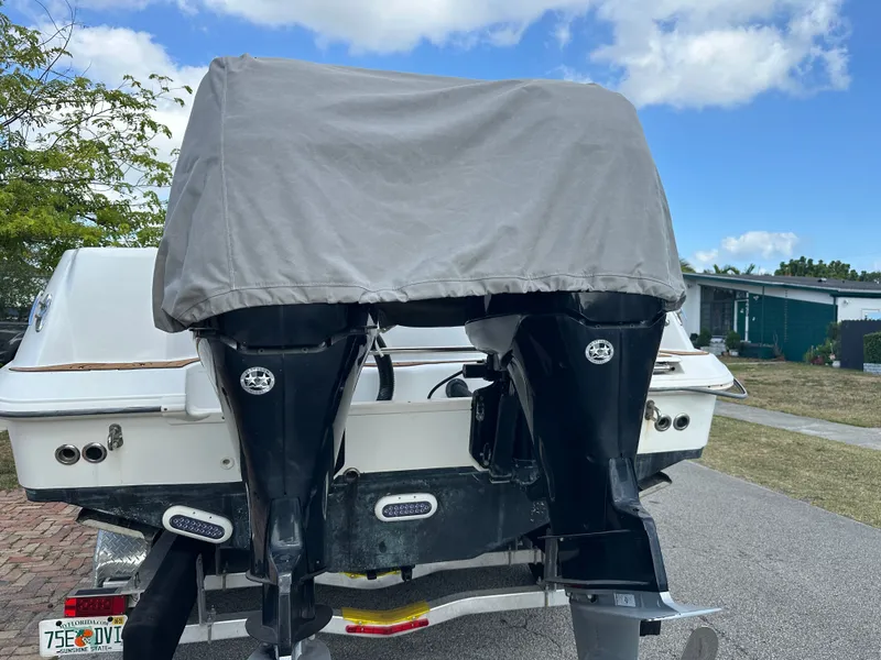 Slide: The Image of 2013 Boston Whaler 320 Outrage with covered motor on trailer. - 34