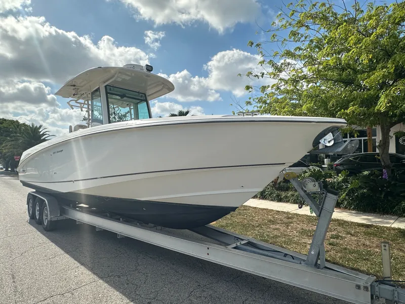 Slide: The Image of 2013 Boston Whaler 320 Outrage on trailer under sunny skies. - 4
