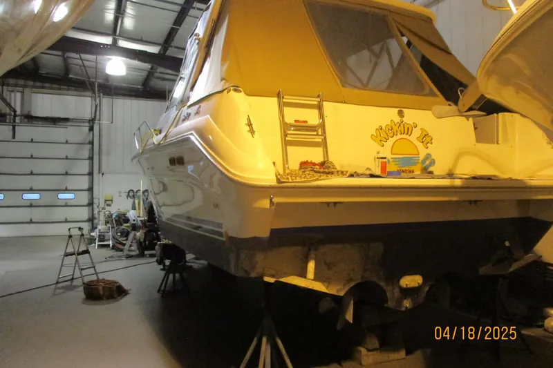 Slide: The Image of 1990 Sea Ray Sundancer 310 in a garage, undergoing maintenance. - 4