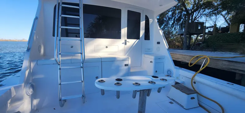 The Image of 2004 Cabo 48 Convertible yacht deck with ladder and fishing rod holders. - 0