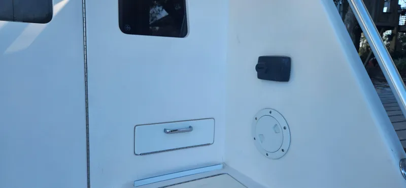 Slide: The Image of 2004 Cabo 48 Convertible yacht interior detail with storage compartment and window. - 10