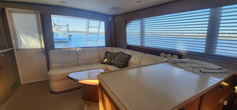 Slide: The Image of Luxurious interior of a 2004 Cabo 48 Convertible yacht with plush seating and ocean view. - 12