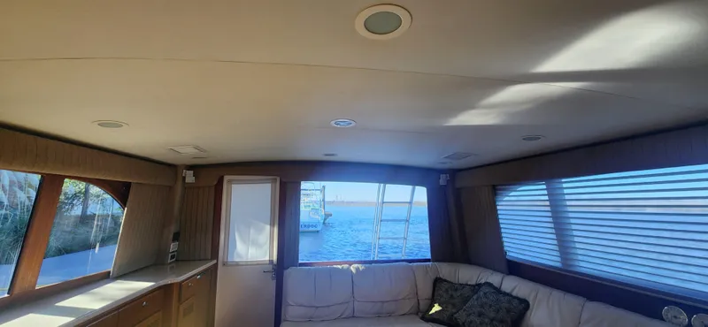 Slide: The Image of Interior of 2004 Cabo 48 Convertible yacht with ocean view through windows. - 13