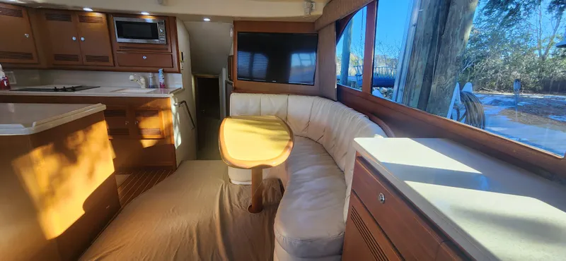 Slide: The Image of Interior of 2004 Cabo 48 Convertible yacht with kitchen and seating area. - 18