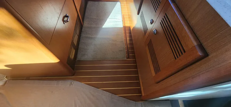 Slide: The Image of Interior of 2004 Cabo 48 Convertible yacht with wooden cabinetry and flooring. - 20