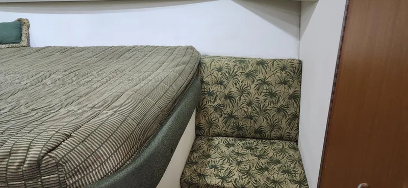 Slide: The Image of Interior of 2004 Cabo 48 Convertible with patterned upholstery and bedding. - 27