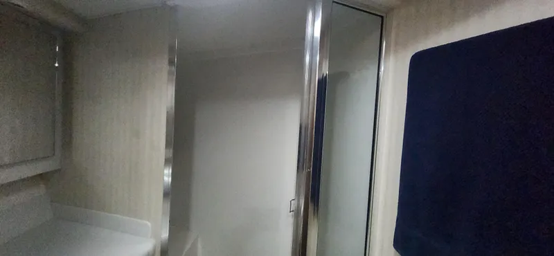 Slide: The Image of Interior of 2004 Cabo 48 Convertible yacht bathroom with mirror and towel. - 35