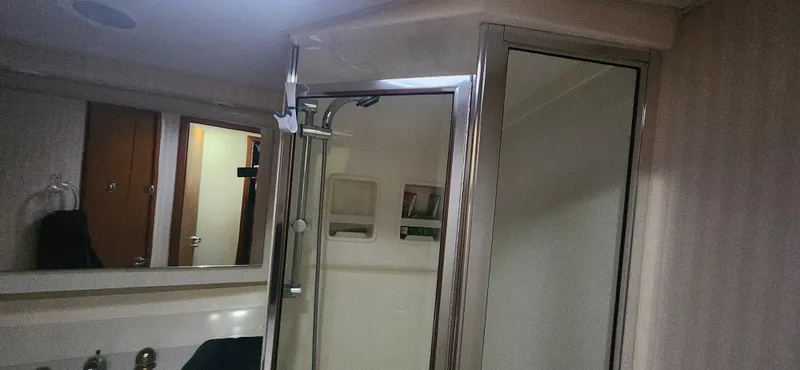 Slide: The Image of Bathroom interior of 2004 Cabo 48 Convertible yacht with shower and mirror. - 36