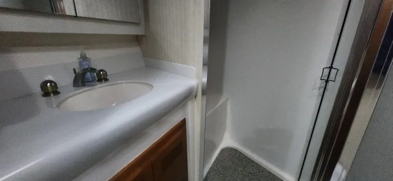 Slide: The Image of 2004 Cabo 48 Convertible yacht bathroom with sink and shower. - 37