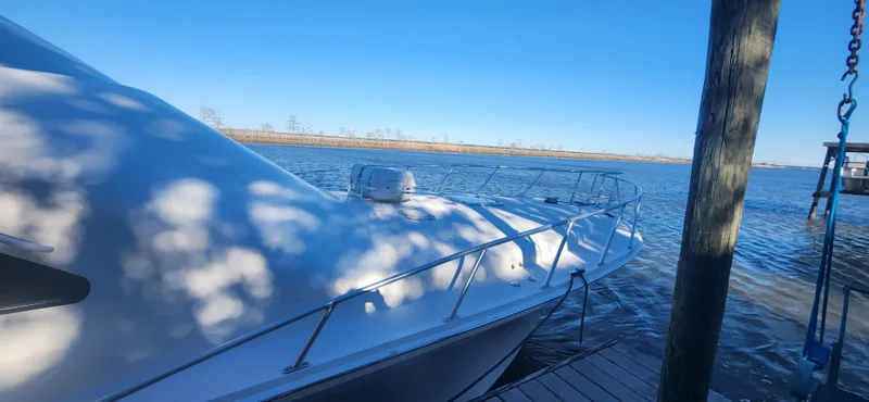 Slide: The Image of 2004 Cabo 48 Convertible yacht docked on a sunny day. - 4