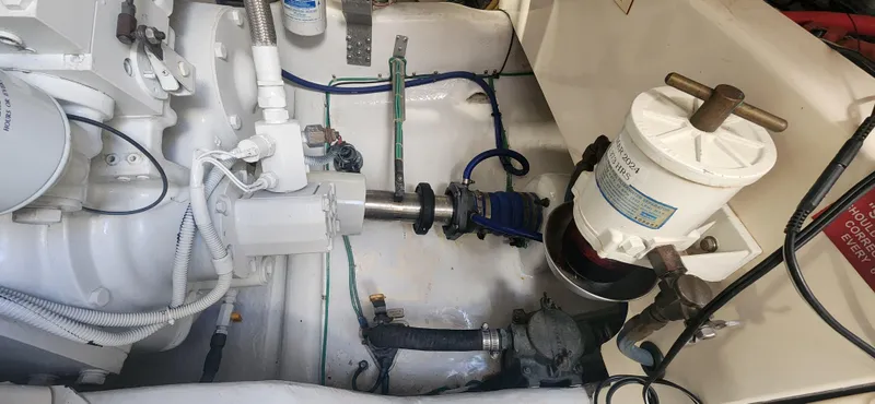 Slide: The Image of Engine room of a 2004 Cabo 48 Convertible boat, showcasing mechanical components and systems. - 45