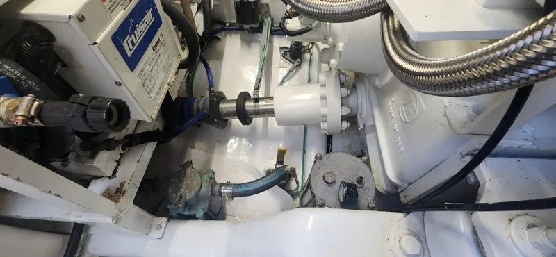 Slide: The Image of Engine room of 2004 Cabo 48 Convertible boat, showcasing mechanical components and wiring. - 46