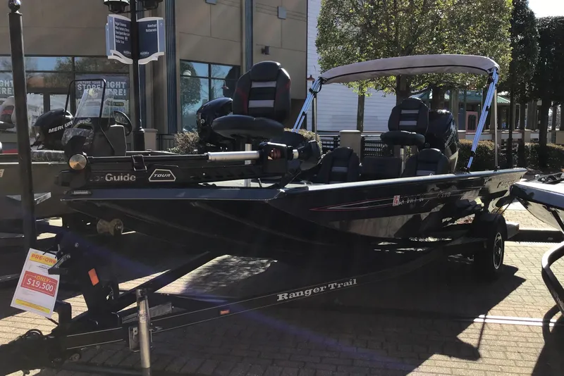 The Image of 2020 Ranger RT178 boat displayed outdoors with price tag, featuring a canopy and seating. - 1