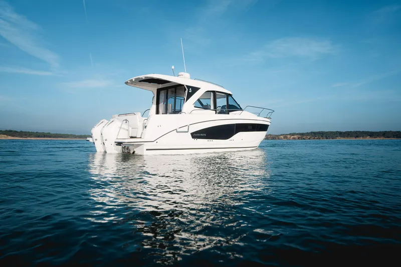 Slide: The Image of 2027 Beneteau Antares 9 on calm water under clear sky. - 1