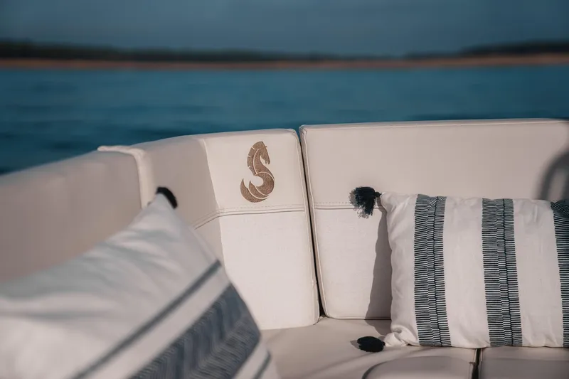 Slide: The Image of Luxurious seating on 2027 Beneteau Antares 9 V2 boat with decorative pillows. - 10