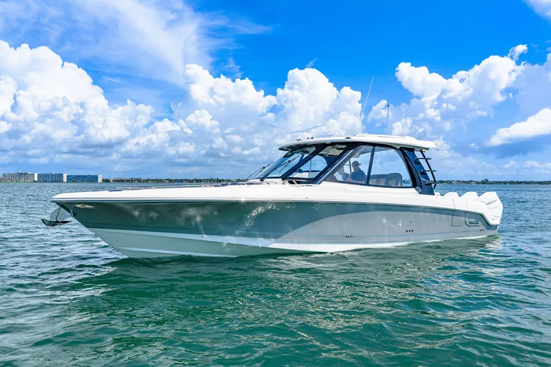 Slide: The Image of 2026 Boston Whaler 380 Realm on calm water under a blue sky. - 1