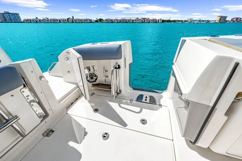Slide: The Image of The image shows the stern of a Boston Whaler 380 Realm boat overlooking turquoise water. - 45