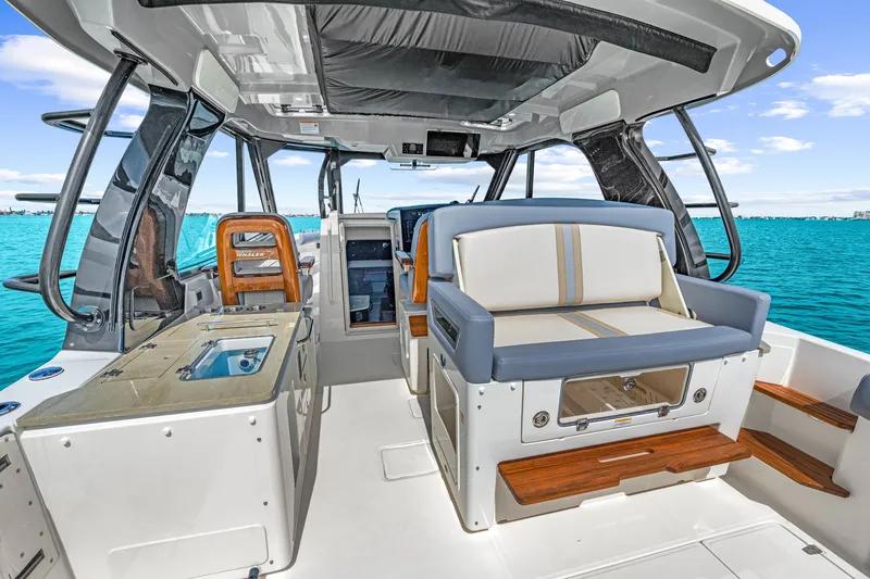 Slide: The Image of The image shows the cockpit of a 2026 Boston Whaler 380 Realm with luxurious seating and modern design. - 47