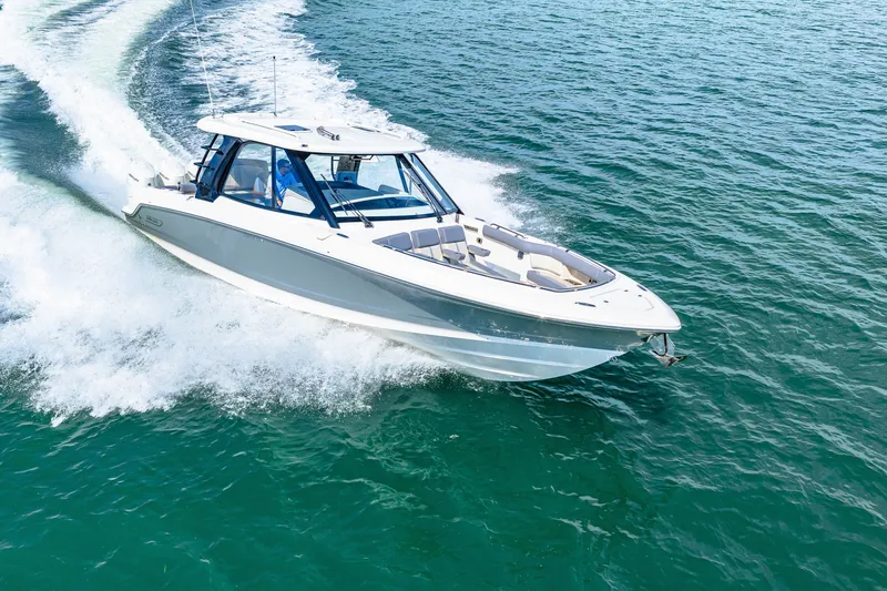 Slide: The Image of A 2026 Boston Whaler 380 Realm speeds across the water, surrounded by splashing waves. - 29
