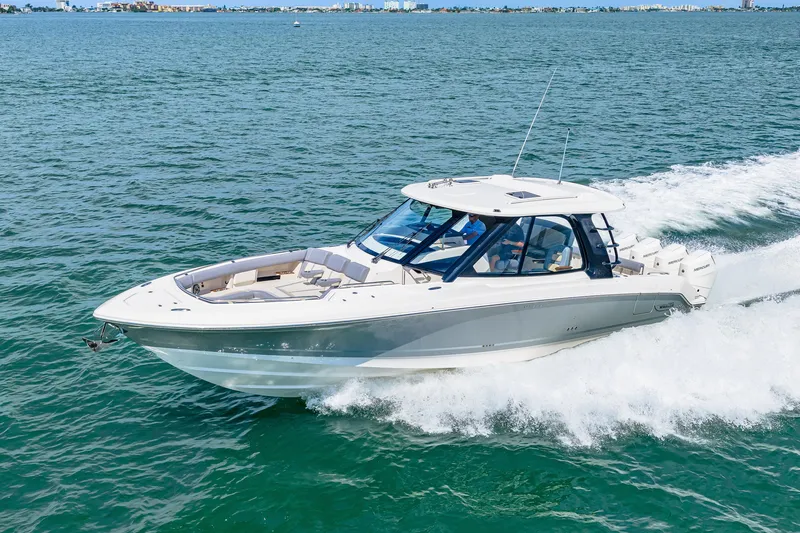 Slide: The Image of A 2026 Boston Whaler 380 Realm speeds across the water, surrounded by blue sea. - 24