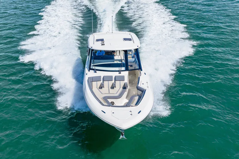 Slide: The Image of The 2026 Boston Whaler 380 Realm speeds across the water, featuring sleek design and spacious deck. - 26