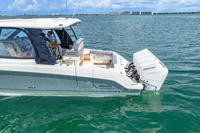 Slide: The Image of 2026 Boston Whaler 380 Realm on calm water with twin Mercury outboard engines. - 11