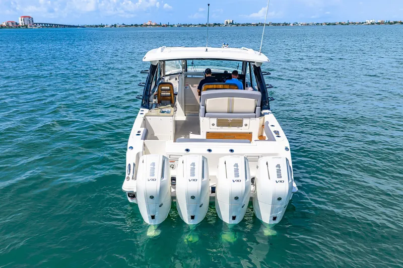 Slide: The Image of 2026 Boston Whaler 380 Realm with four outboard engines on calm water. - 7