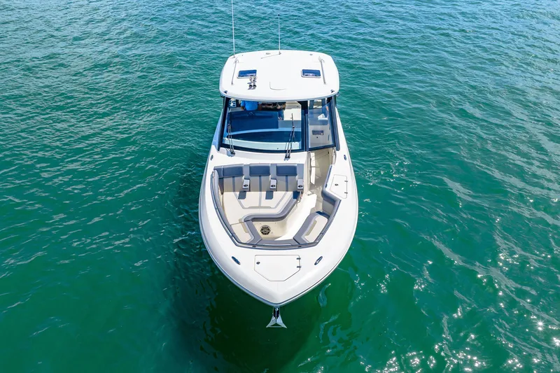 Slide: The Image of The 2026 Boston Whaler 380 Realm glides on calm water. It features a sleek design and comfortable seating. - 4