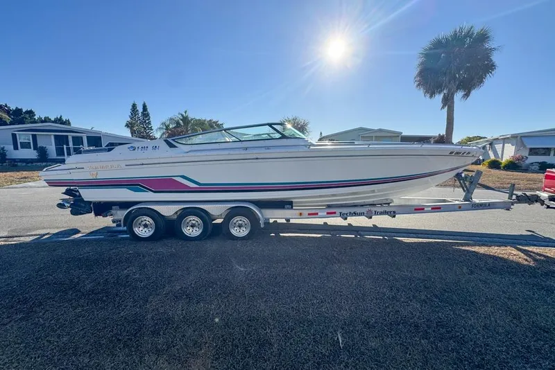 Slide: The Image of 1989 Formula 292 SR-1 boat on trailer, sunny day, residential background. - 10