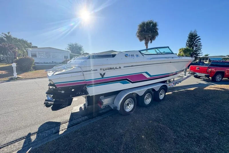 Slide: The Image of 1989 Formula 292 SR-1 boat on trailer, parked in sunny residential area. - 11