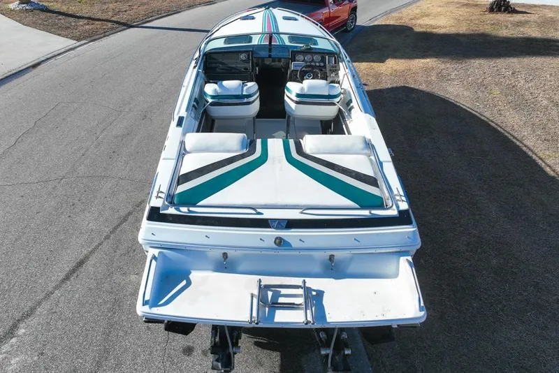 Slide: The Image of 1989 Formula 292 SR-1 boat with striped upholstery, parked on a road. - 14