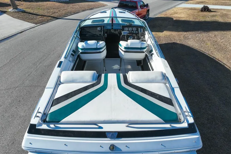 Slide: The Image of 1989 Formula 292 SR-1 speedboat with striped upholstery, parked on a street. - 15