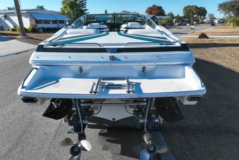Slide: The Image of 1989 Formula 292 SR-1 boat, rear view with dual propellers, parked on a residential street. - 17