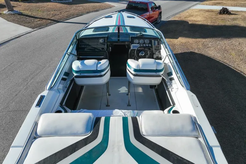 Slide: The Image of 1989 Formula 292 SR-1 boat interior with striped seats and dashboard, parked on a road. - 21
