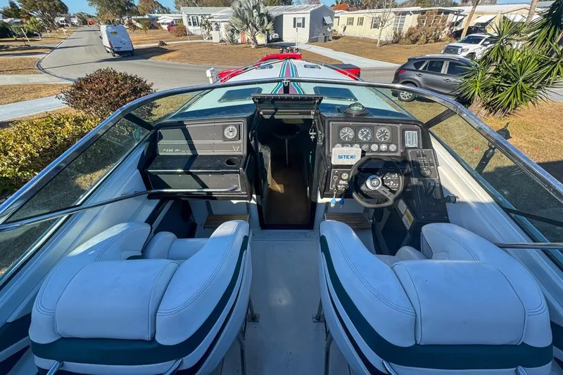 Slide: The Image of 1989 Formula 292 SR-1 boat interior with dashboard and seating, parked in a residential area. - 24