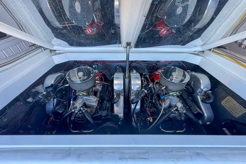 Slide: The Image of 1989 Formula 292 SR-1 engine compartment with dual engines and chrome air filters. - 36