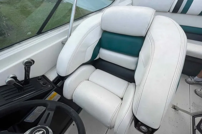 Slide: The Image of 1989 Formula 292 SR-1 boat interior with white and teal seating, steering wheel, and controls. - 44