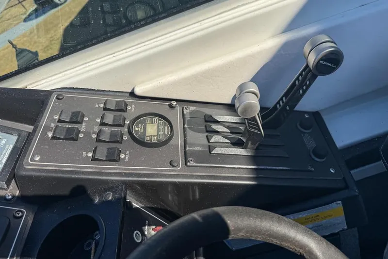 Slide: The Image of Control panel of a 1989 Formula 292 SR-1 boat with levers and switches. - 48