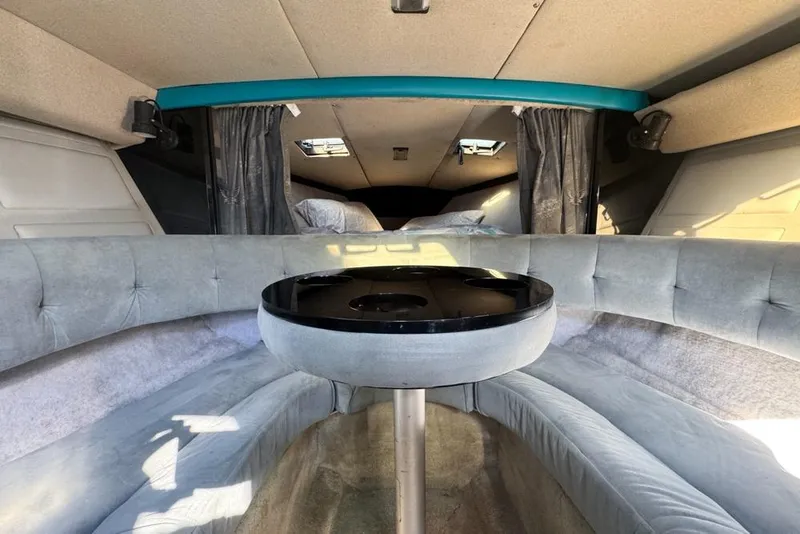 Slide: The Image of Interior of a 1989 Formula 292 SR-1 boat with plush seating and a central table. - 52