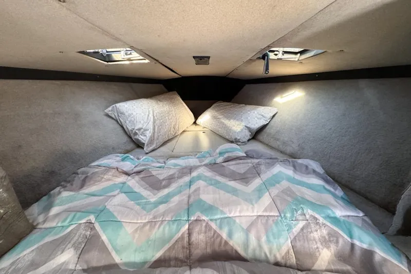 Slide: The Image of Cozy cabin interior of 1989 Formula 292 SR-1 with patterned bedding and pillows. - 56