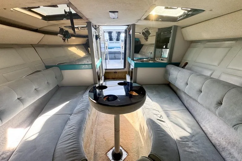 Slide: The Image of 1989 Formula 292 SR-1 boat interior with seating, table, and kitchenette. - 58