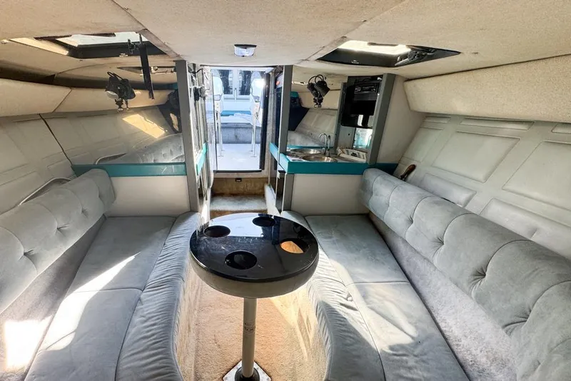 Slide: The Image of Interior of 1989 Formula 292 SR-1 boat with seating, table, and kitchenette. - 59