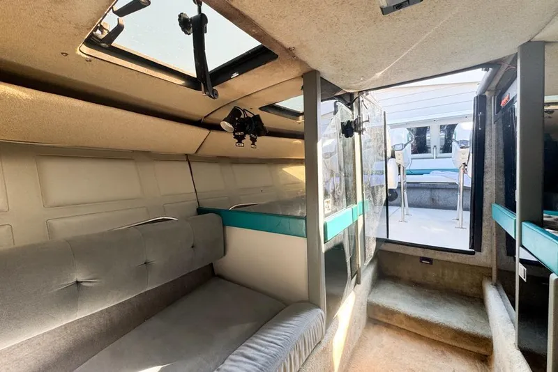 Slide: The Image of Interior of a 1989 Formula 292 SR-1 boat with seating and open hatch. - 60