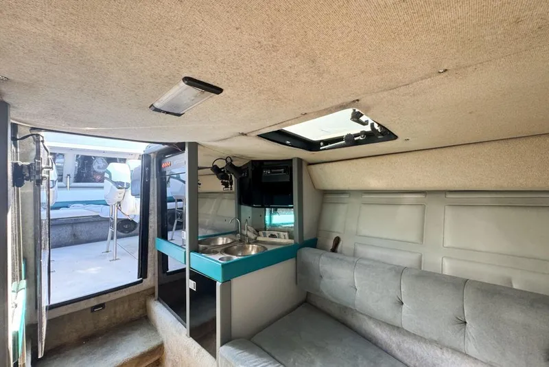 Slide: The Image of Interior of 1989 Formula 292 SR-1 boat with kitchenette and seating area. - 61