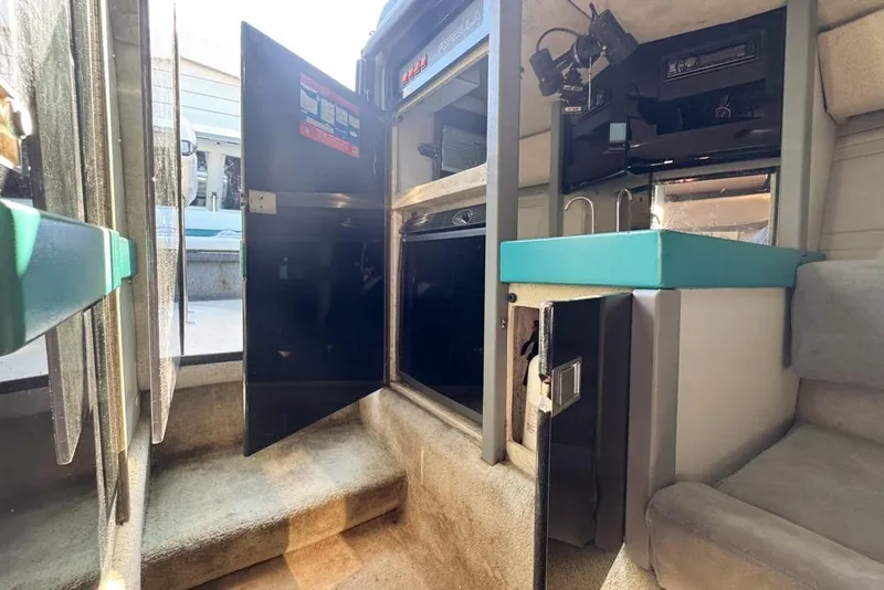 Slide: The Image of Interior of a 1989 Formula 292 SR-1 boat with open storage compartments. - 64