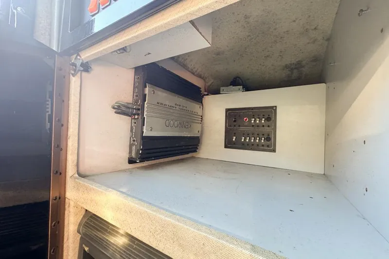 Slide: The Image of 1989 Formula 292 SR-1 interior electronics compartment with Kenwood amplifier and control panel. - 66