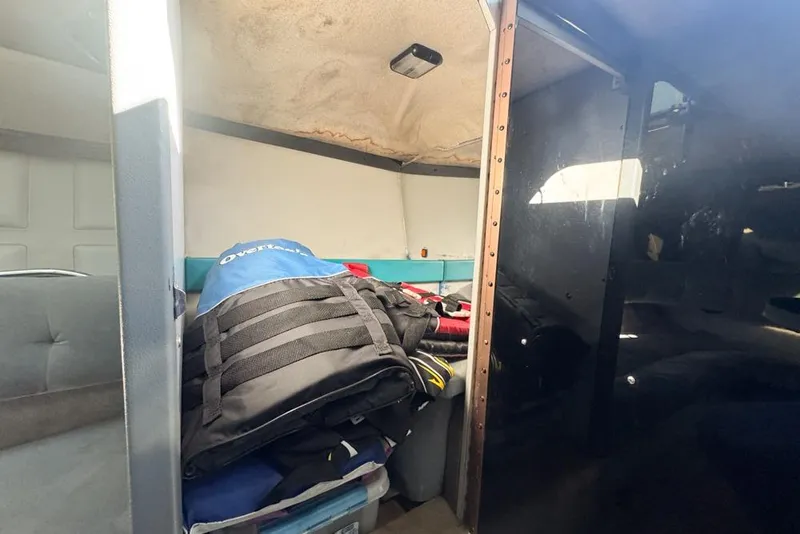 Slide: The Image of Interior of a 1989 Formula 292 SR-1 boat with stored gear and equipment. - 69