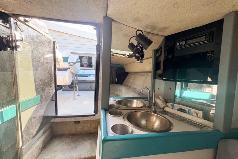 Slide: The Image of Interior of a 1989 Formula 292 SR-1 boat with kitchenette and seating area. - 71