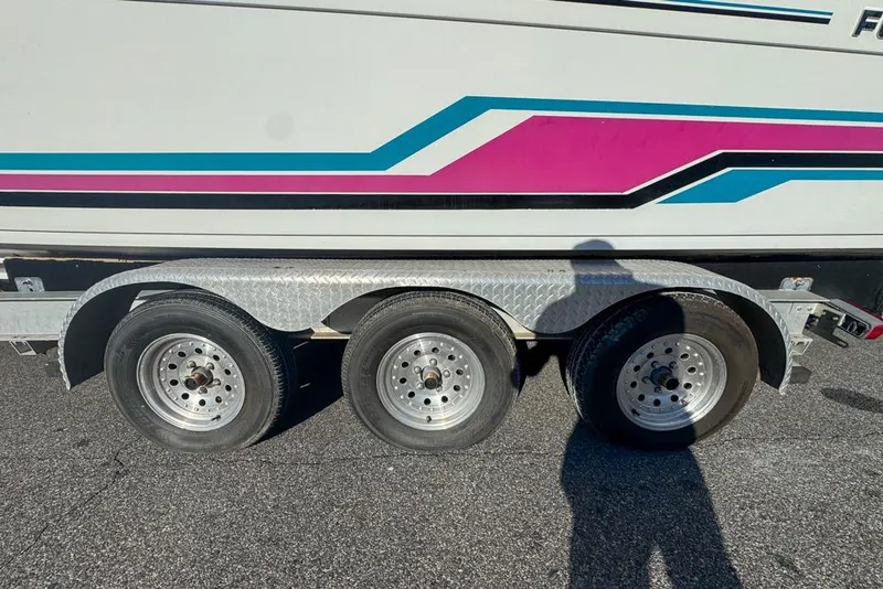 Slide: The Image of 1989 Formula 292 SR-1 boat trailer with colorful stripes and triple axle wheels. - 76