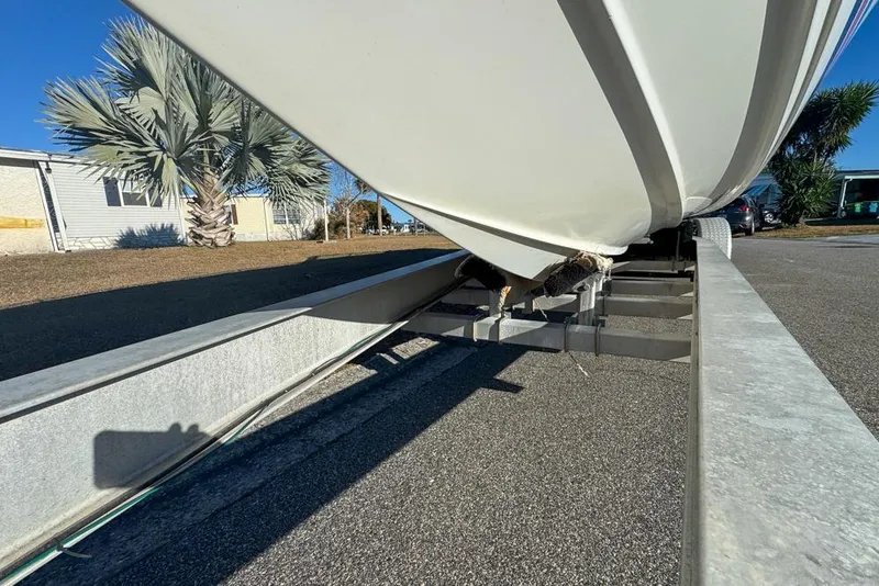 Slide: The Image of 1989 Formula 292 SR-1 boat on trailer, parked near palm trees and houses. - 78